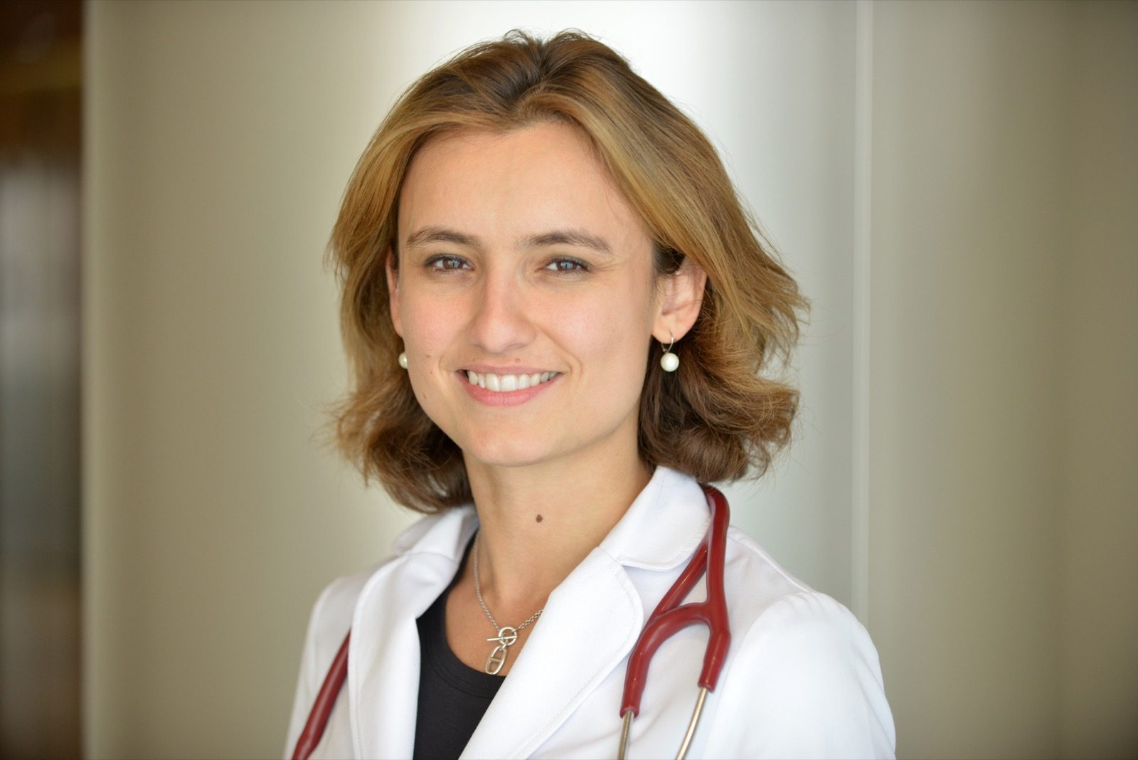 Dr. Jenelle Jindal in clinical attire